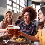 photo of alt bash with four young female friends meeting for drinks and food at a restaurant