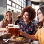 photo of alt bash with four young female friends meeting for drinks and food at a restaurant