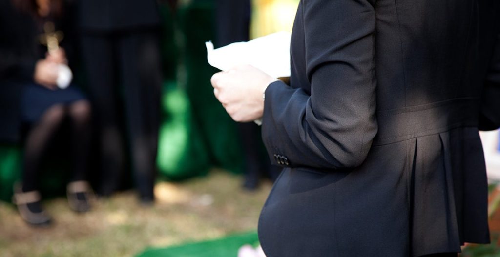 A person giving a eulogy at a funeral