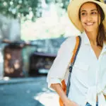 coastal grandmother with portrait woman in straw hat and white shirt walking