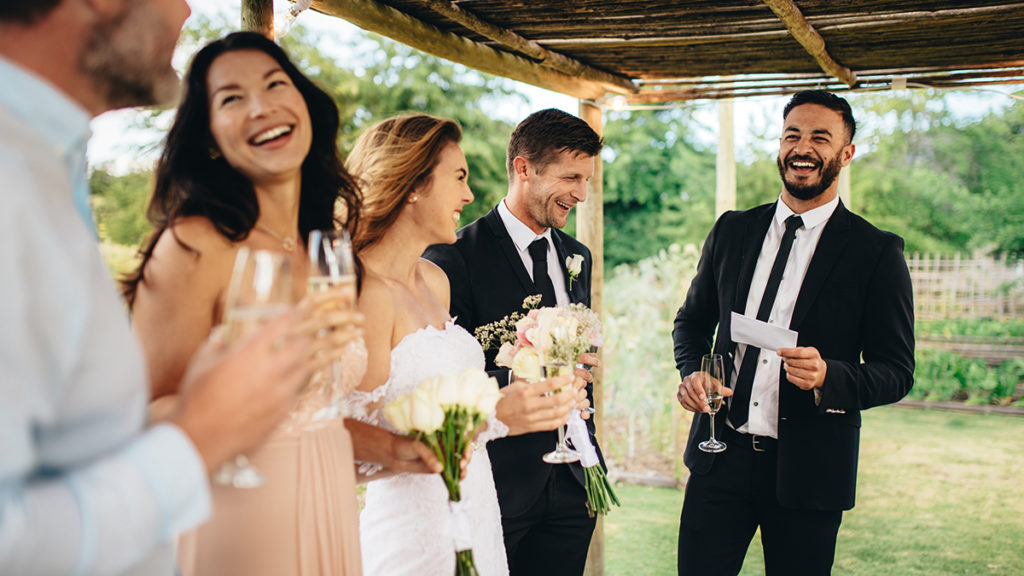 wedding toast with Best man giving speech to newlywed couple at wedding reception
