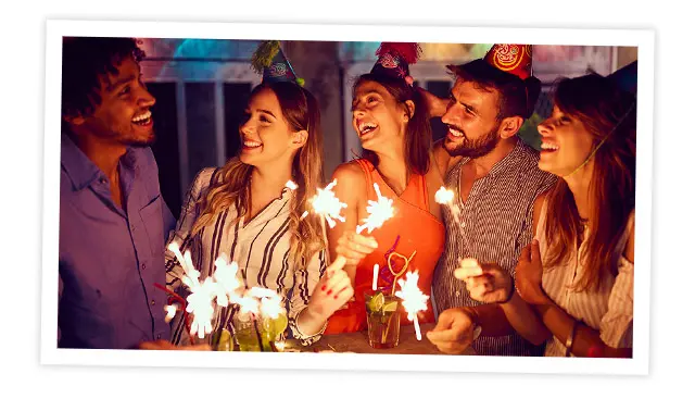 A photo of people celebrating birthdays with sparklers