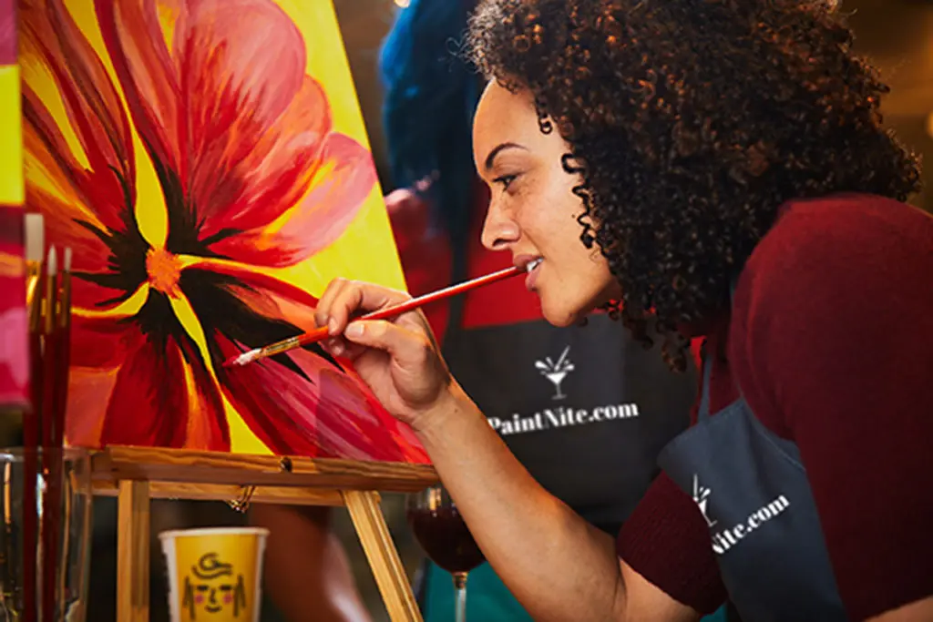 Photo of woman creating a flower painting