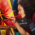 Photo of woman creating a flower painting
