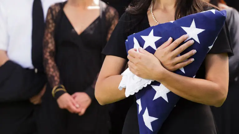 funeral etiquette with woman holding american flag