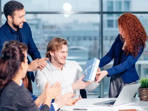 show appreciation with Colleagues celebrating birthday party in office smiling giving presents to boss