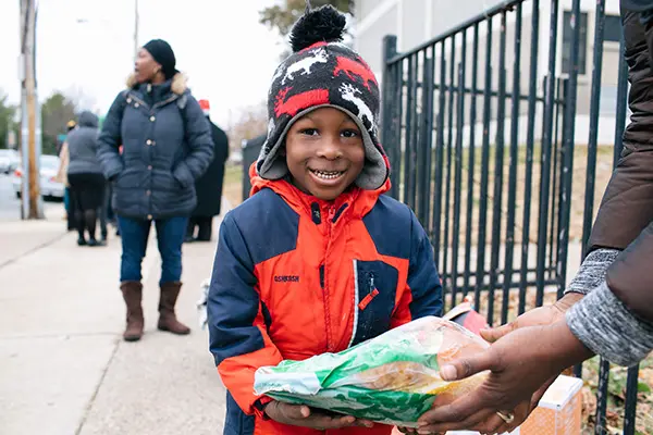 feeding america child holds bread