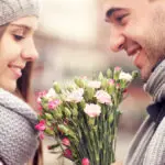 history of gifting flowers with man giving woman flowers