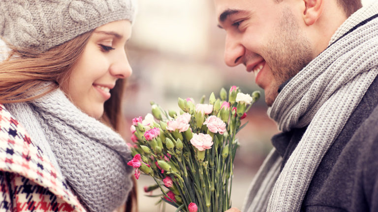 history of gifting flowers with man giving woman flowers