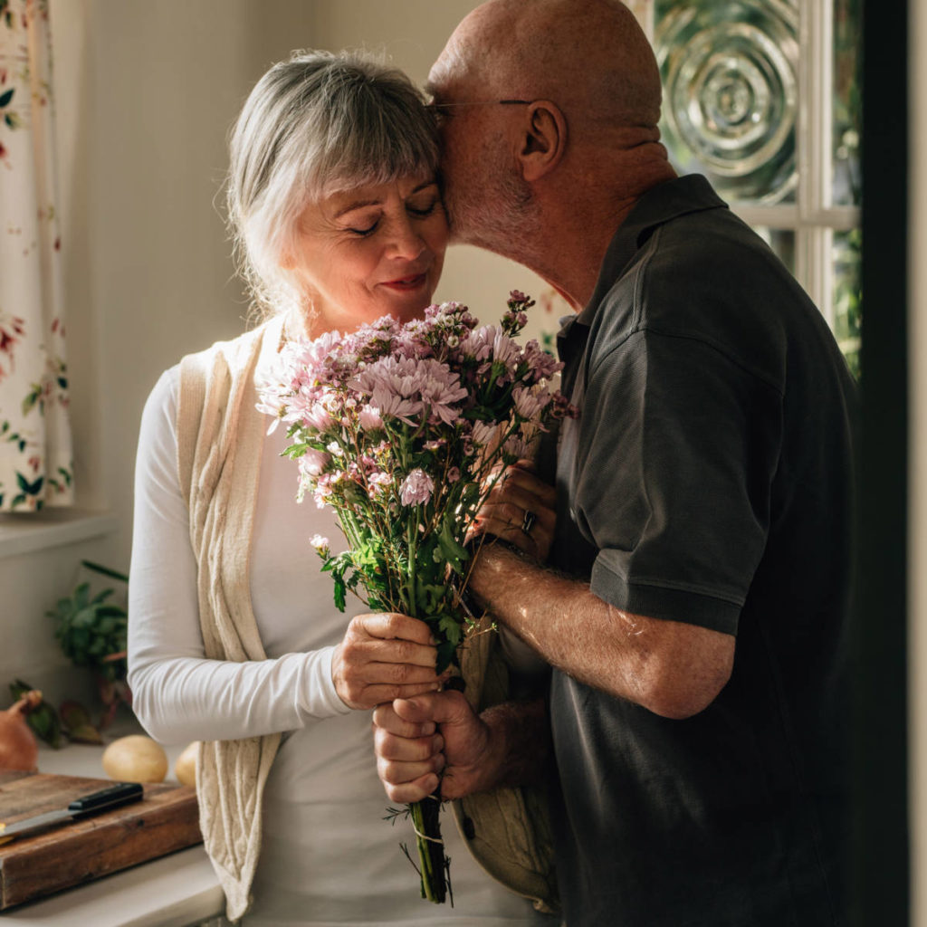 history of gifting flowers with older couple giving flowers