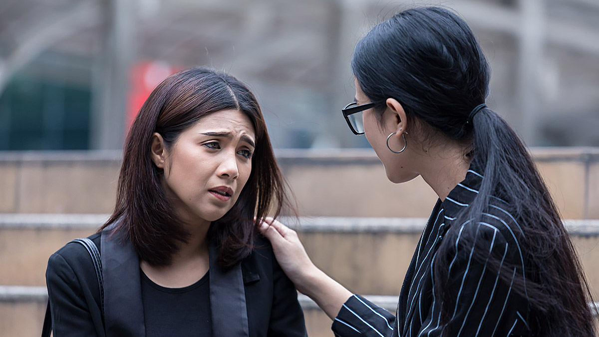 https://www.flowers.com/blog/wp content/uploads///how to support a grieving co worker with female colleague consoling female co worker