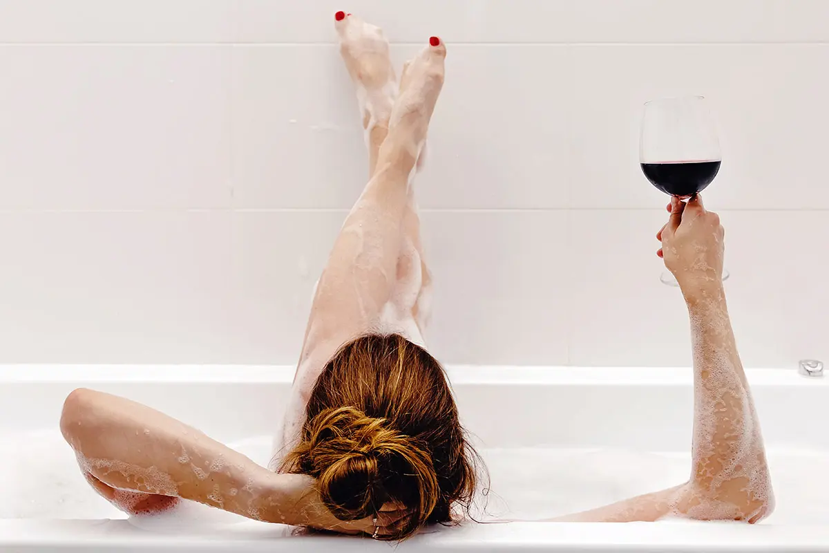 birthday gifts for capricorn with woman taking bath and drinking wine