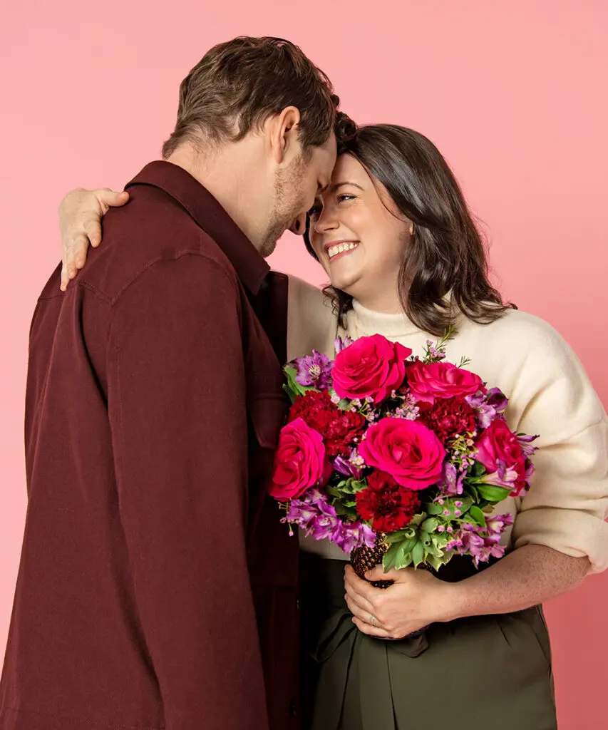 valentines day facts with couple embracing with flowers