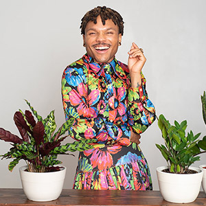 plant kween interview with pk standing with plants on a table