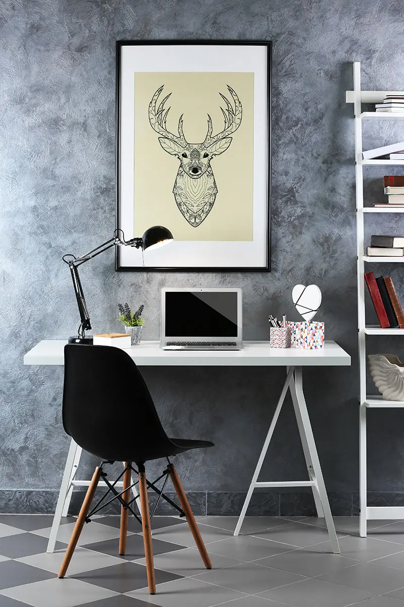 brighten up your office space with artwork hanging above desk
