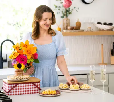 spring birthdays with woman eating meat and cheese in kitchen
