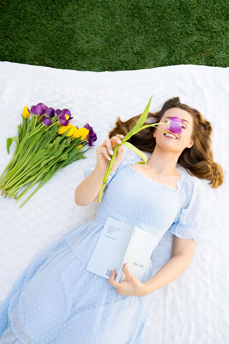 spring self care ideas with woman relaxing on blanket
