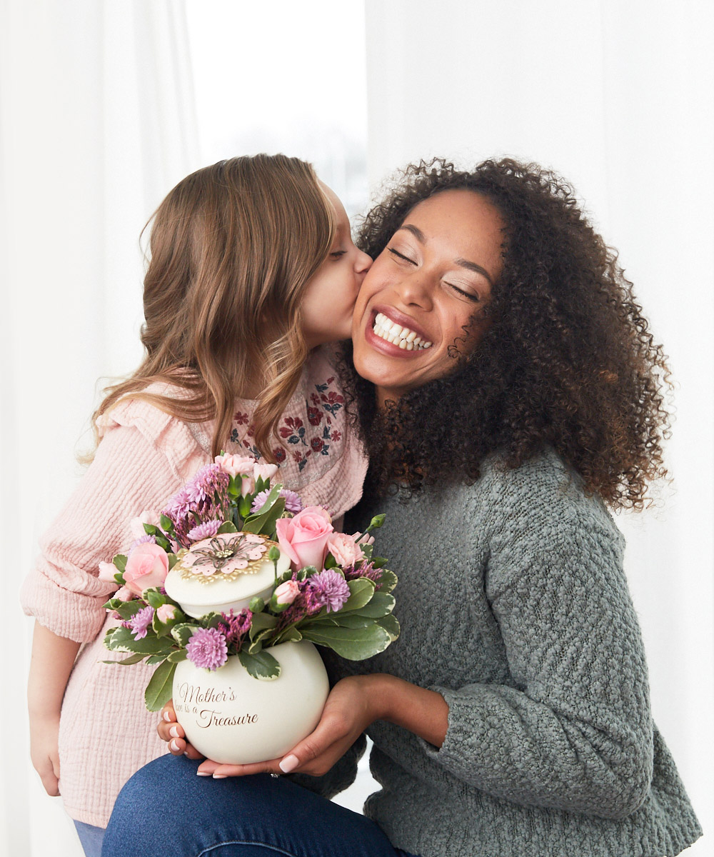 gifts for non traditional moms with young daughter kissing mom with flowers