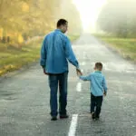 father and son walk in nature