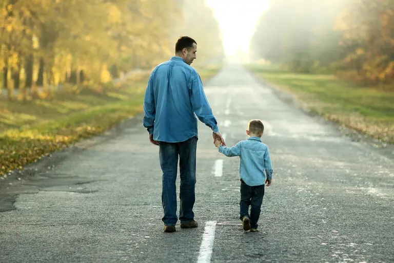 father and son walk in nature