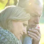 Sad senior wife embracing crying husband, relative loss, grief a