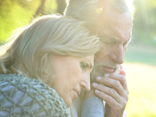 Sad senior wife embracing crying husband, relative loss, grief a