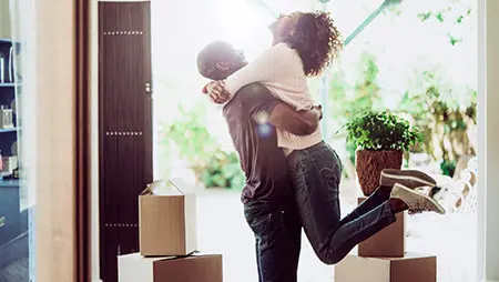 housewarming gift ideas with couple celebrating moving into first home