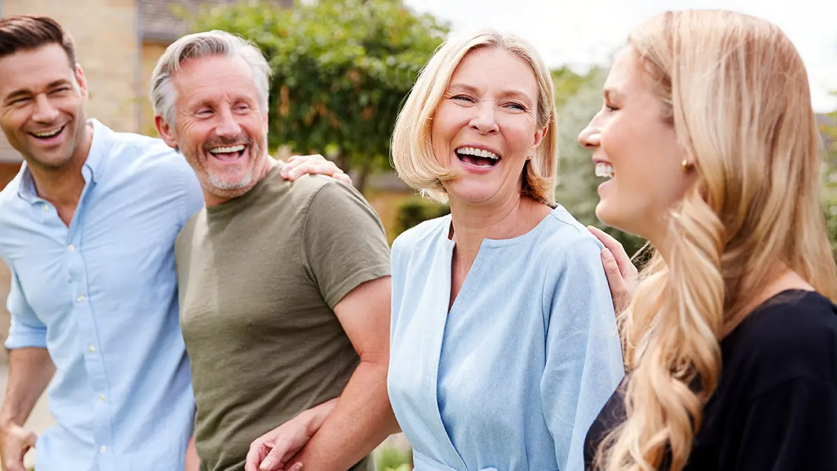 parents' day with Family With Senior Parents And Adult Offspring Walking And Talking In Garden Together