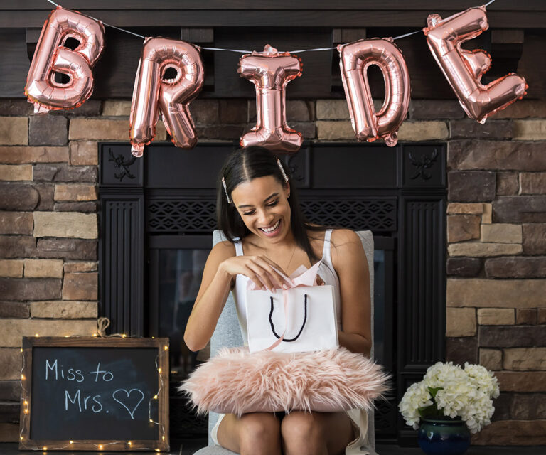 Soon to be bride opening a present at her bridal shower