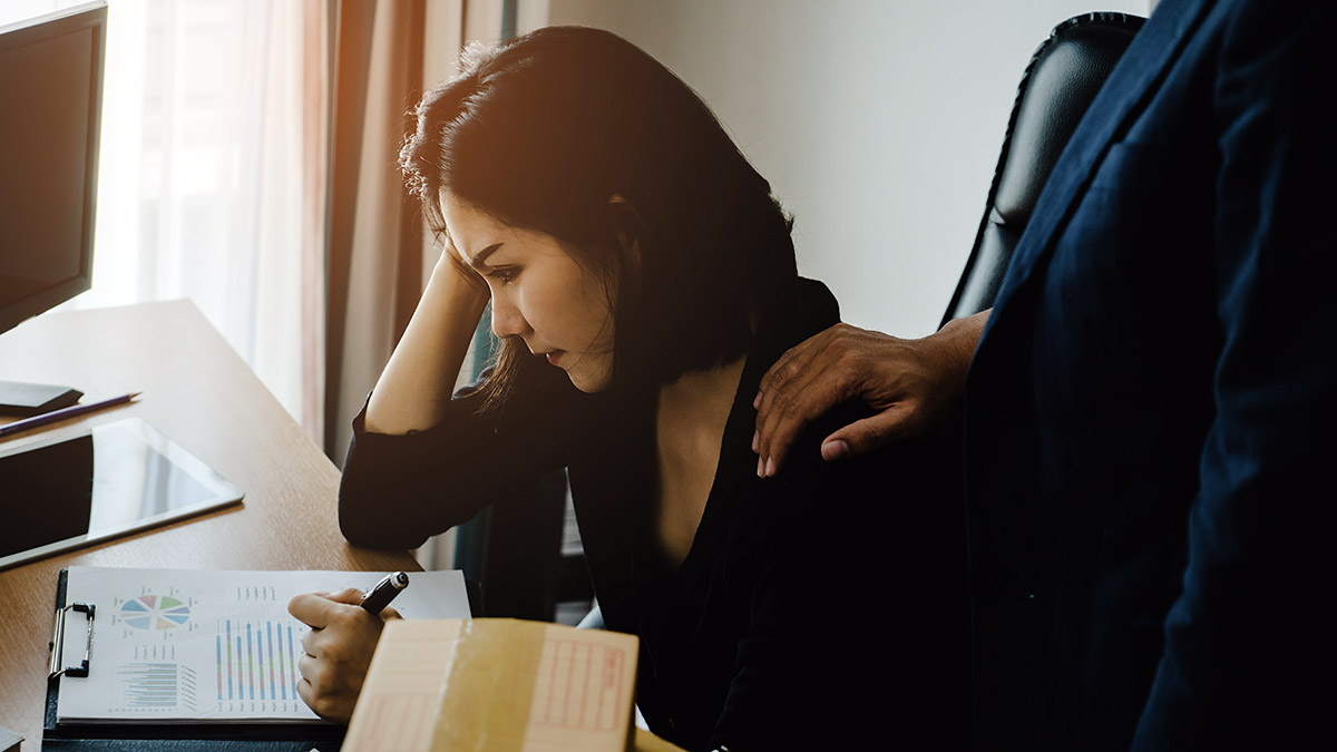 bereavement leave with boss consoling stressed female office worker