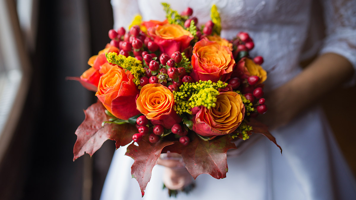 Bride holding wedding Colorful bouquet of autumn flowers