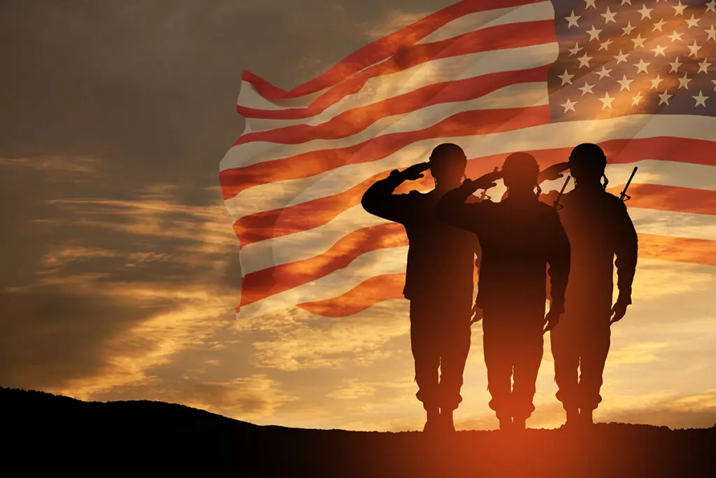 USA army soldiers saluting on a background of USA flag. Greeting card for Veterans Day, Memorial Day, Independence Day.