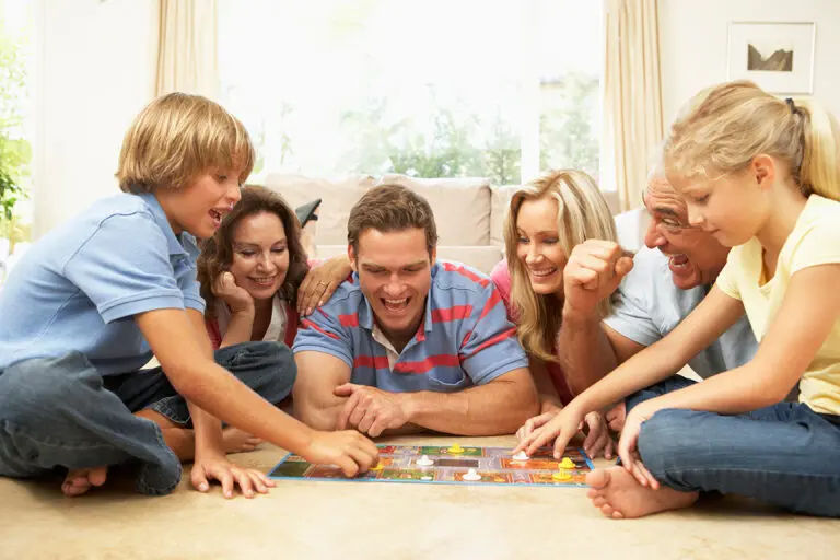 The Week After Christmas: Making the Most of Family Time Family Playing Board Game At Home With Grandparents Watching