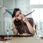 Upset drunk woman celebrating her birthday party alone
