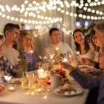family with sparklers having dinner party at home