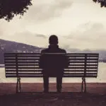 Como, Italy February , : A lonely man sitting on the ben