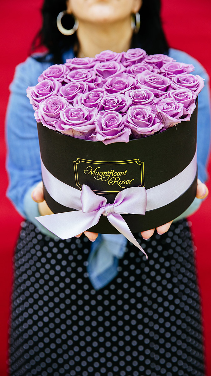 preserved roses woman holding open box of lavender roses