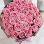 preserved roses woman holding open box of pink roses above view