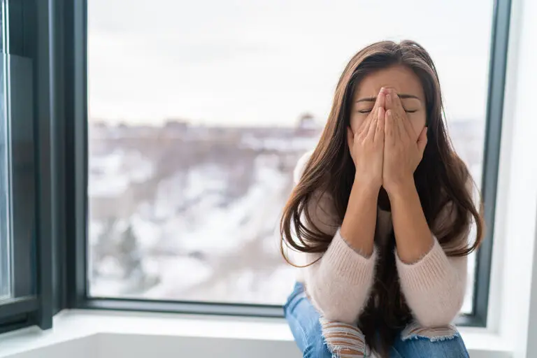 Navigating the Winter Blues: Strategies to Brighten Your Days & Boost Your Mood Anxiety winter depression woman having a panic attack and a hard time breathing. Home alone girl crying stressed depressed.