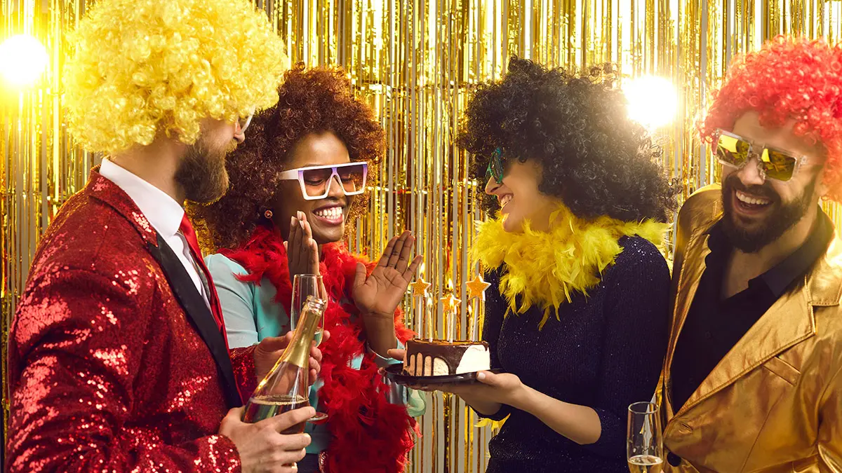 40th birthday ideas with Group of happy friends congratulating young black woman at retro themed birthday party