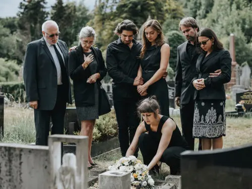 Family laying flowers on the grave